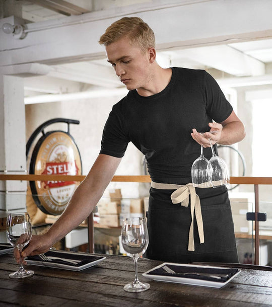 Homme travaillant en restauration qui porte un uniforme de travail du magasin Uniformes Town & Country, à Laval